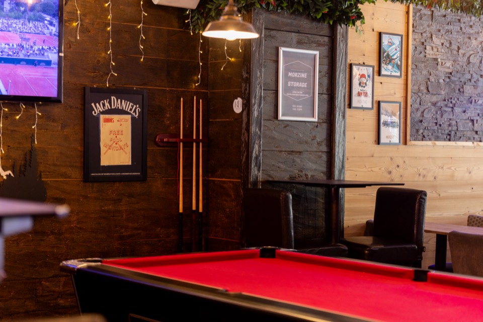 Games area with pool table and TV